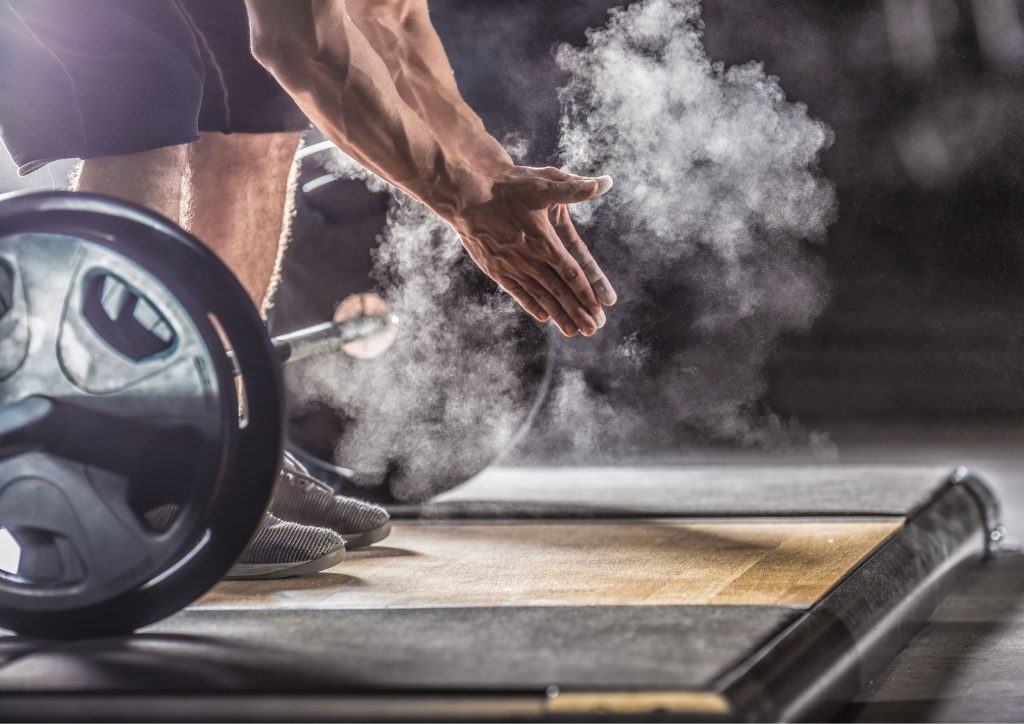 Image of a man about to perform one of our top barbell leg workouts