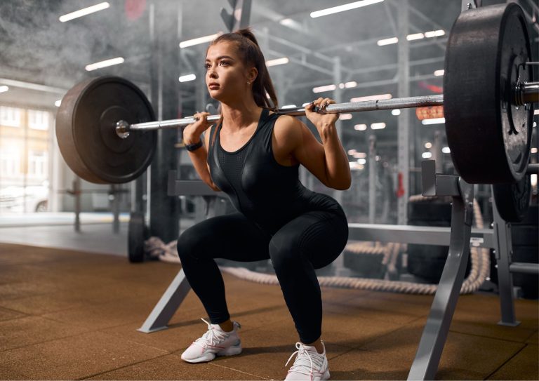 Image of a woman performing one of rhinofit's barbell leg workouts