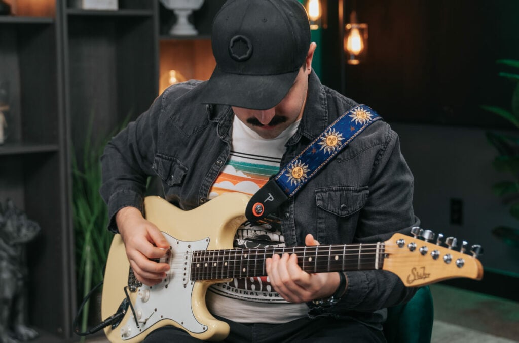 Drums Vs. Guitar: Here's The One You Should Learn 4 guitarist focused on learning guitar