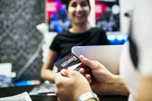 woman at front desk automating the check in process