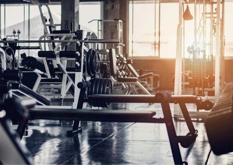 Image of a variety of gym equipment in a fitness facility. This image represents step 5 of how to start a gym