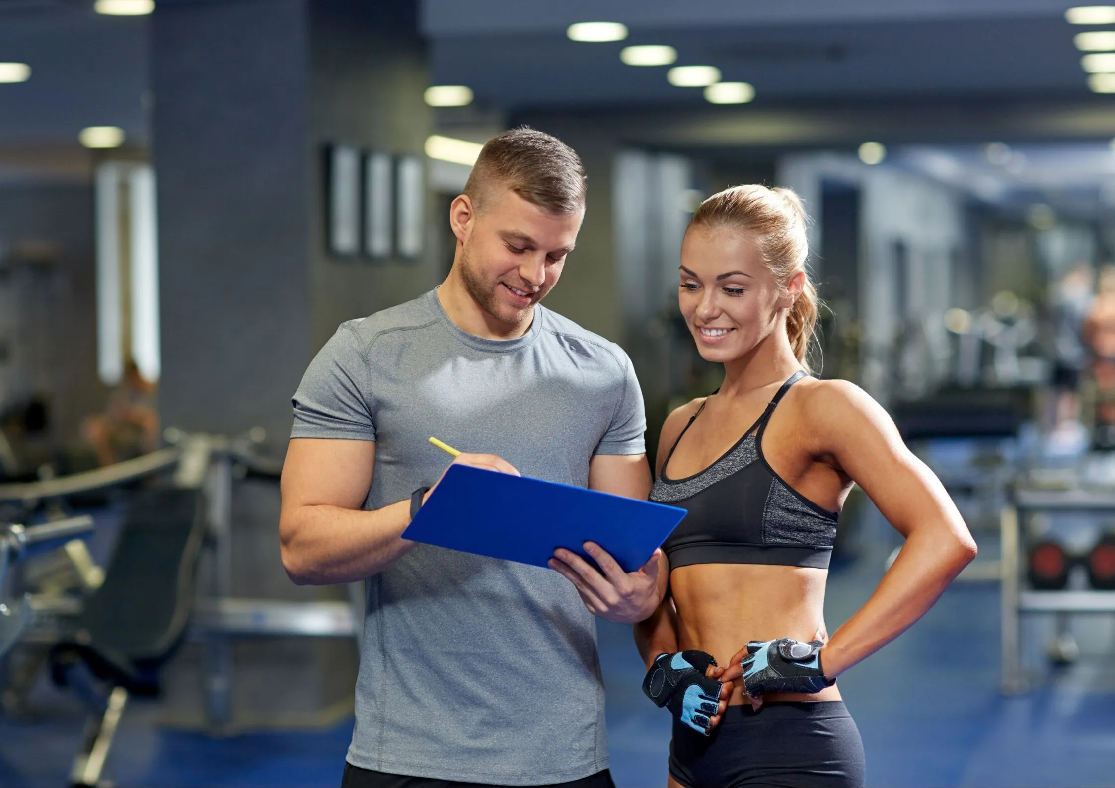 Image of a personal trainer giving a gym member a fitness assessment & tests