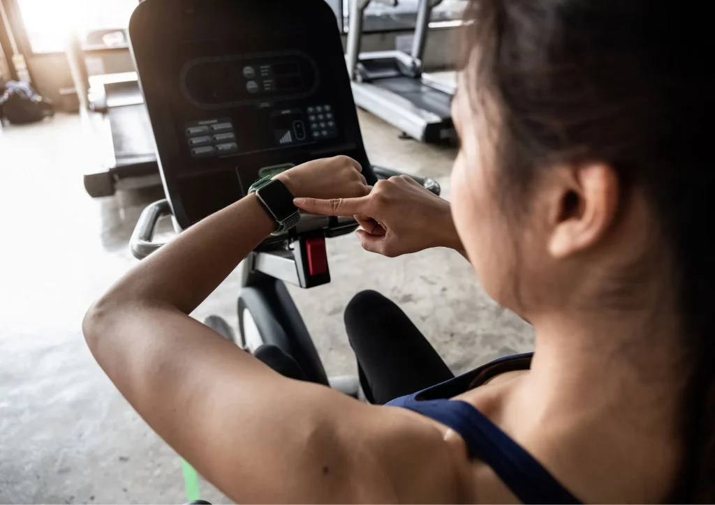 Image of a woman doing a workout and checking her new fitness wearable device