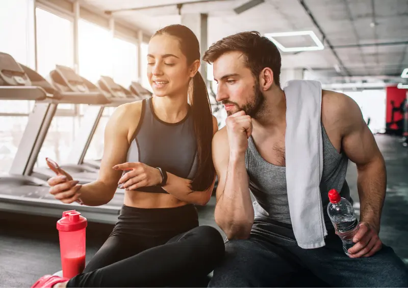 Image of gym members using the best gym software and fitness app while working out