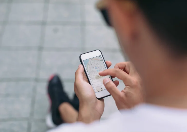 Image of a man looking for a business on a map using SEO for gyms