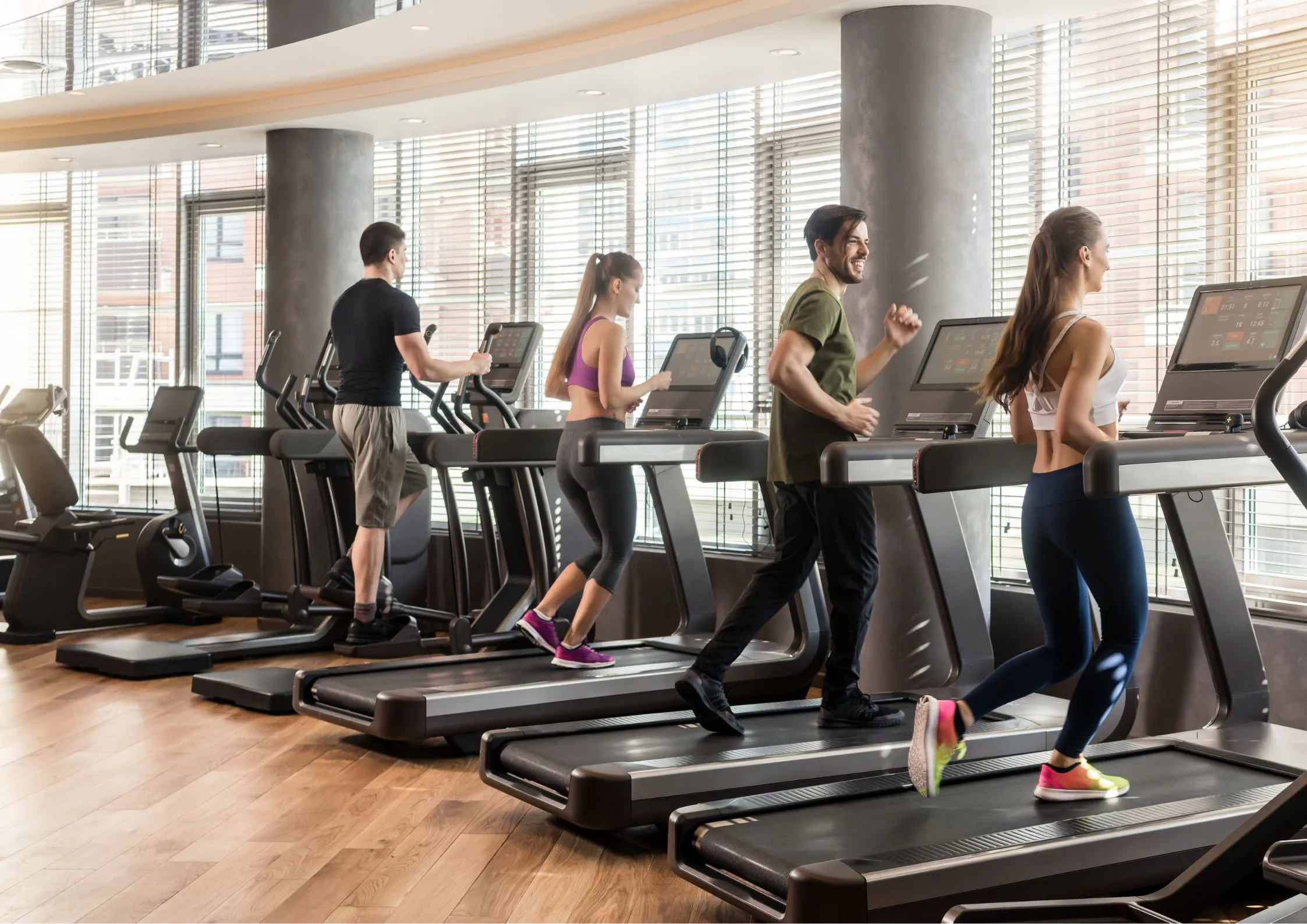 Image of members running at a fitness cub representing the 20 types of popular gyms